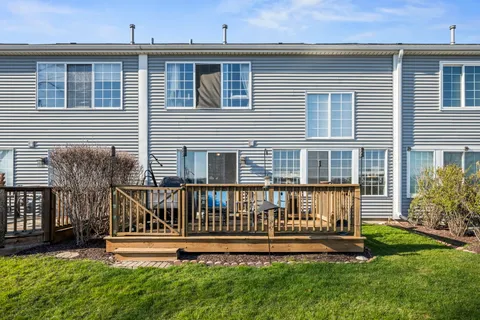 a front view of a house with a yard table and chairs