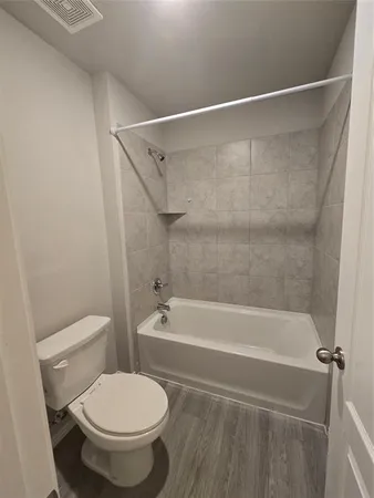 a bathroom with a toilet and a bathtub