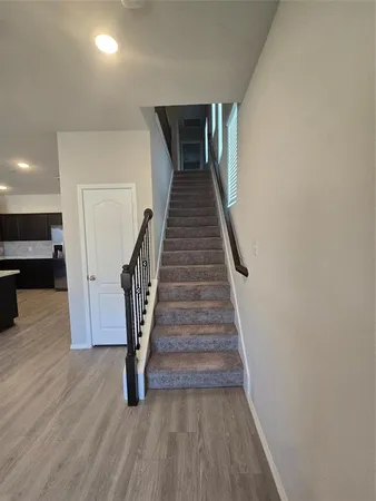 a view of entryway and hall with wooden floor