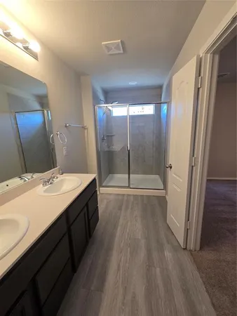 a bathroom with a double vanity sink and mirror