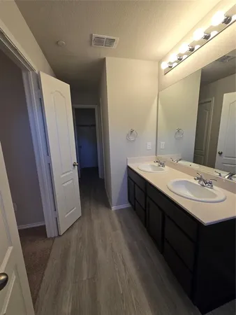 a bathroom with a double vanity sink and mirror