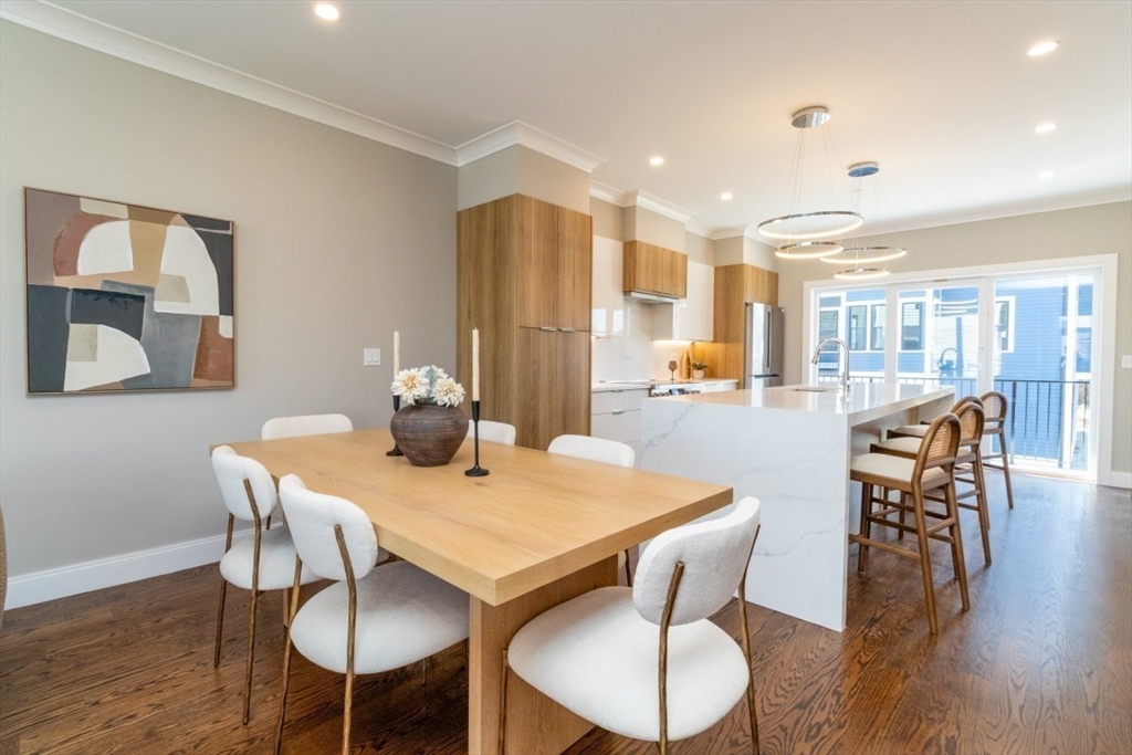 15 Tanglewood Road, Unit A Boston, MA 02126 - Photo 5 of 28 a view of a dining room with furniture wooden floor and chandelier