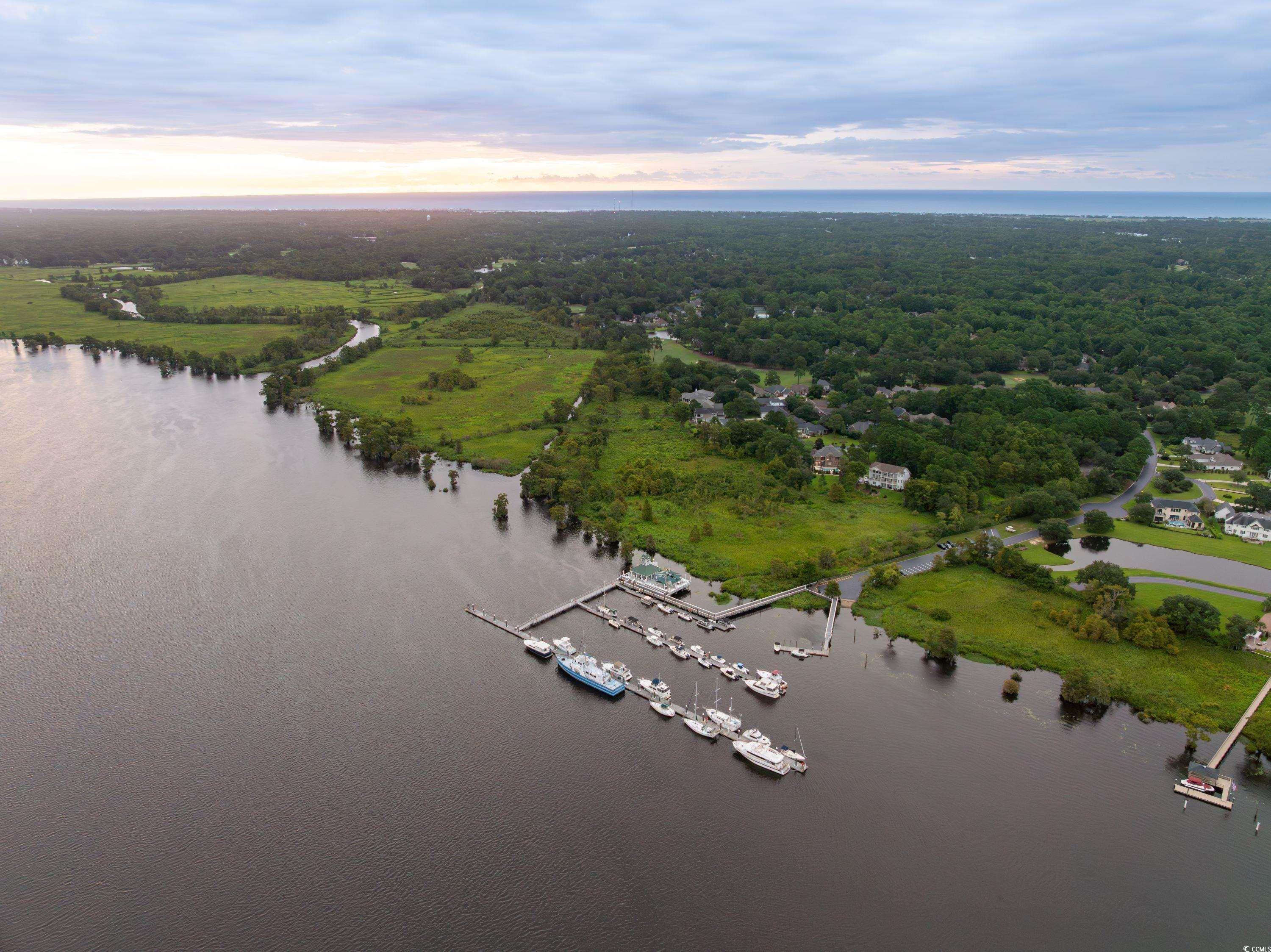 64 Condor Court Pawleys Island, SC 29585 - Photo 11 of 15 Aerial view of property's location featuring a nearby body of water, a local golf course, and nearby suburban area