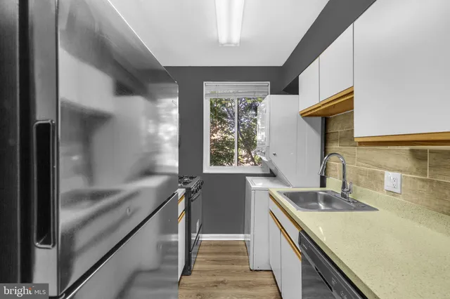 a kitchen with a sink and a refrigerator