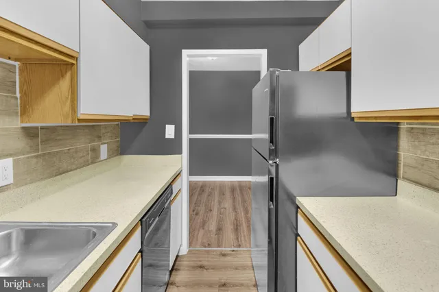 a kitchen with a refrigerator and a sink