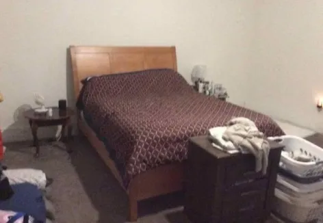 a bedroom with a bed and a window