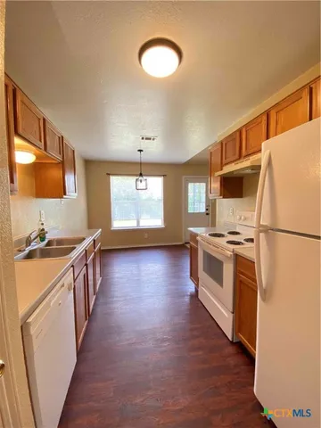 a kitchen with stainless steel appliances a stove a sink and a refrigerator