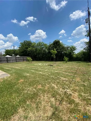 a view of a pool in front of the house