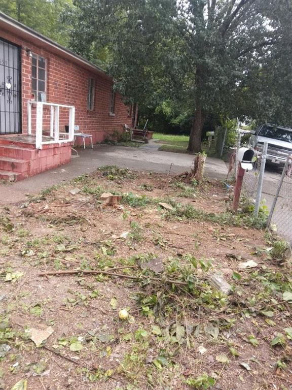 a backyard of a house with barbeque oven table and chairs