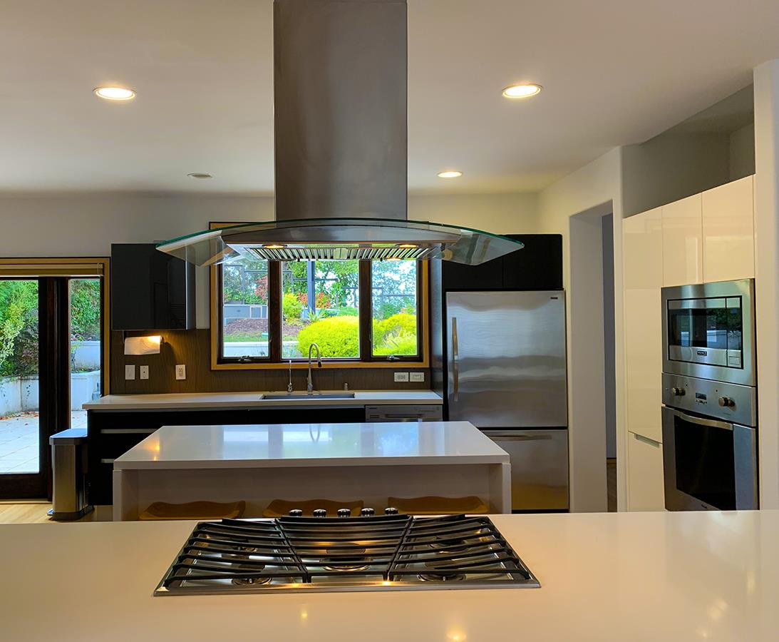 2912 Hillside Drive Burlingame, CA 94010 - Photo 5 of 19 a kitchen with kitchen island granite countertop a stove and a refrigerator