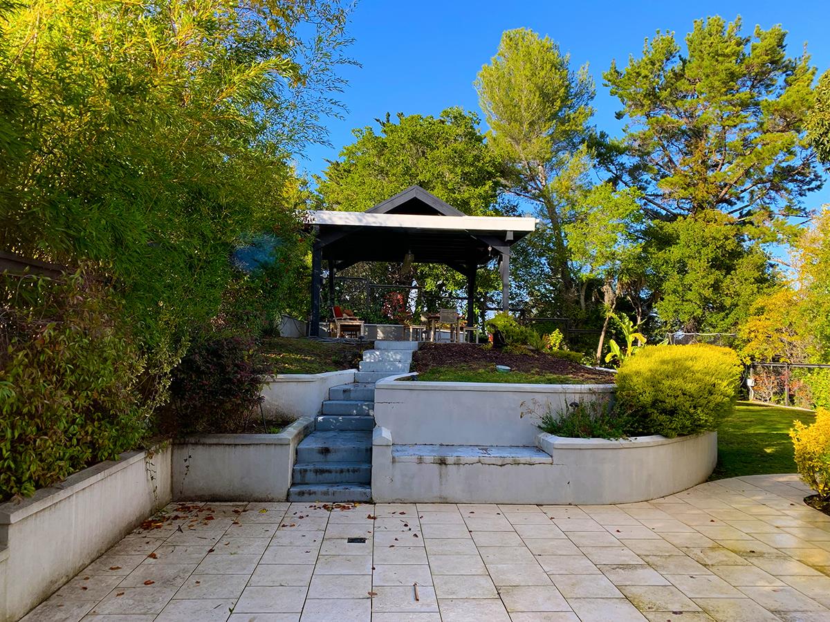 2912 Hillside Drive Burlingame, CA 94010 - Photo 7 of 19 a view of a fountain with flower plants