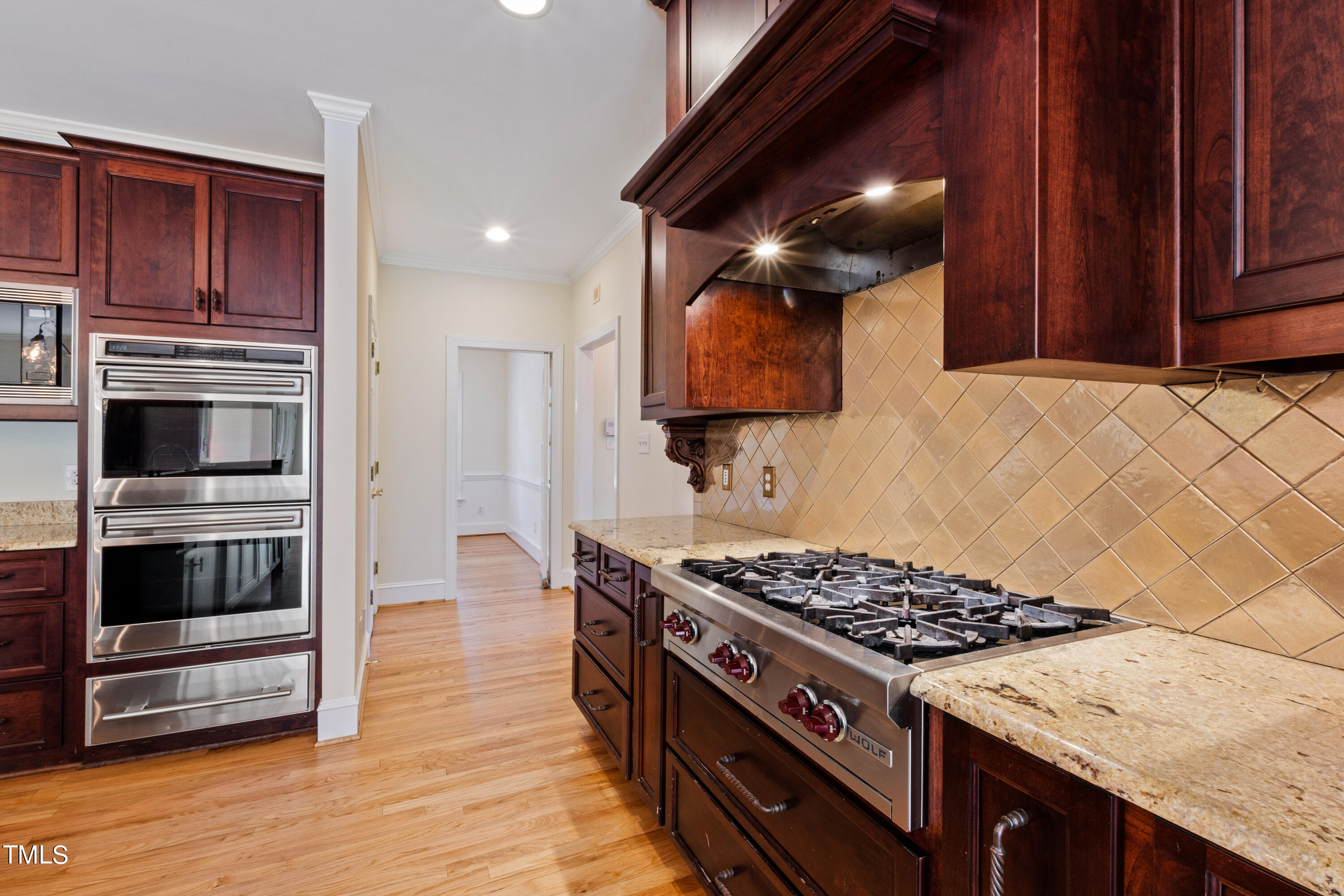 1804 Mcdonald Lane Raleigh, NC 27608 - Photo 12 of 62 a kitchen with wooden cabinets and a stove top oven