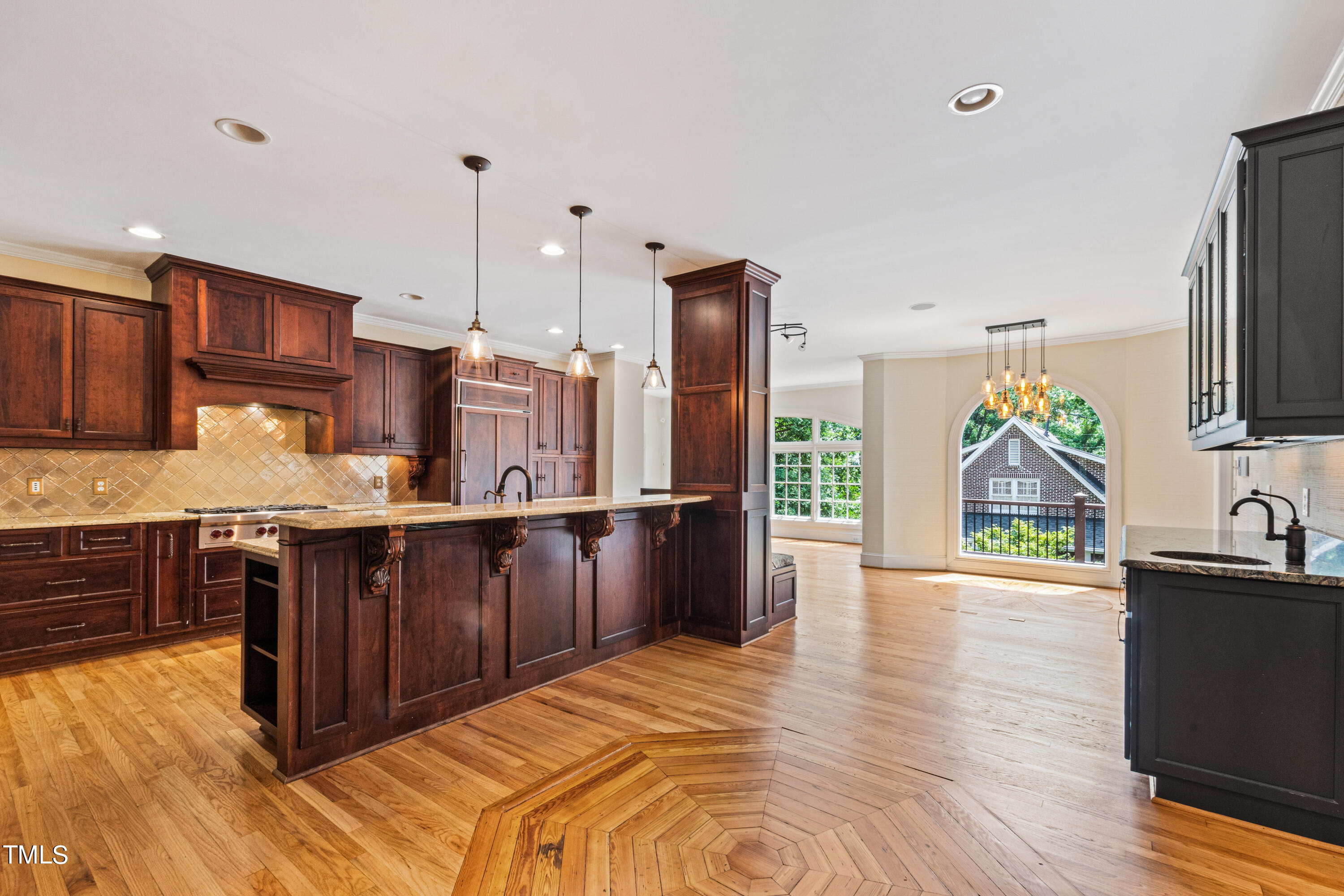 1804 Mcdonald Lane Raleigh, NC 27608 - Photo 13 of 62 a kitchen with stainless steel appliances granite countertop a refrigerator a sink dishwasher a stove and a dining table with wooden floor