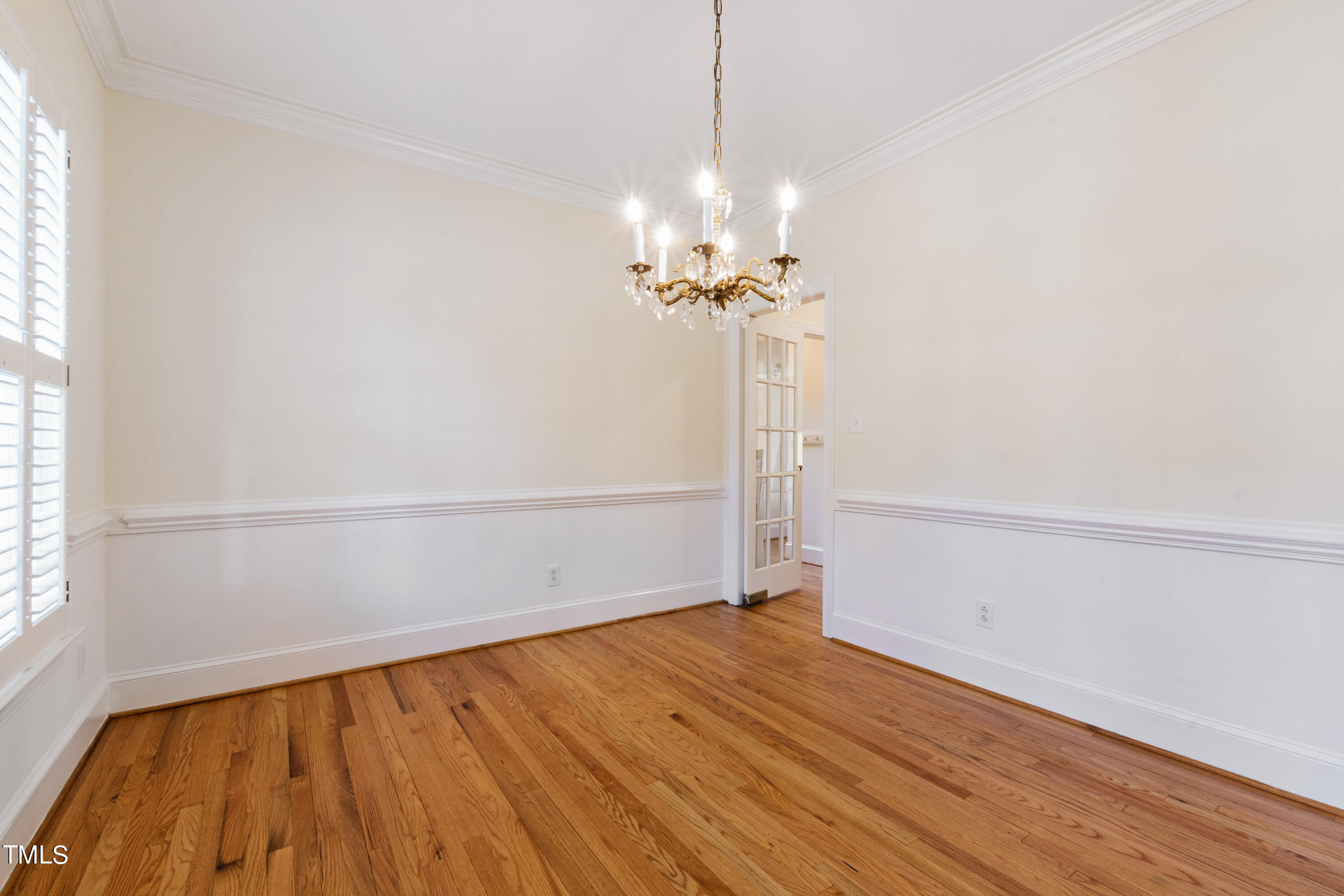 1804 Mcdonald Lane Raleigh, NC 27608 - Photo 17 of 62 a view of a room with wooden floor and a ceiling fan