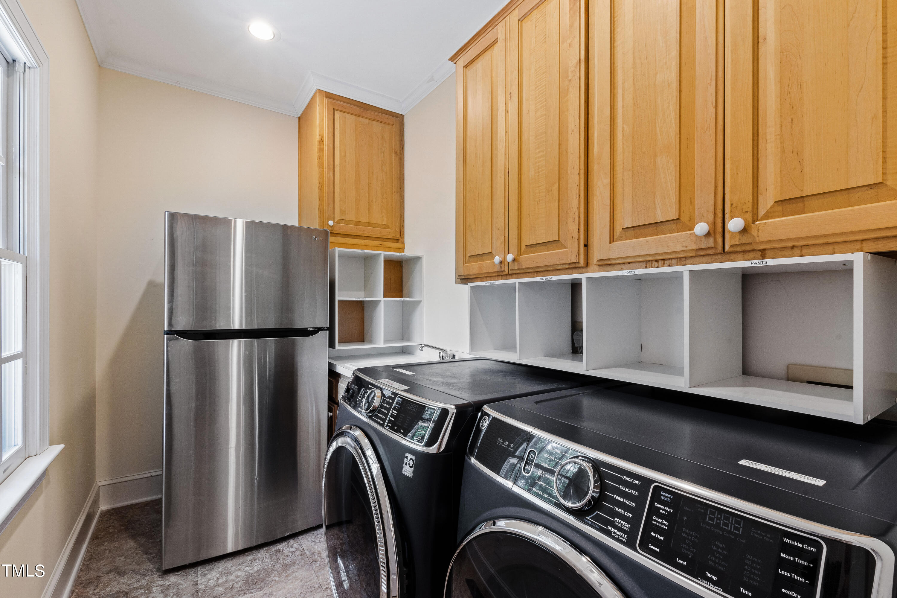 1804 Mcdonald Lane Raleigh, NC 27608 - Photo 22 of 62 a kitchen with stainless steel appliances granite countertop a refrigerator a sink and white cabinets