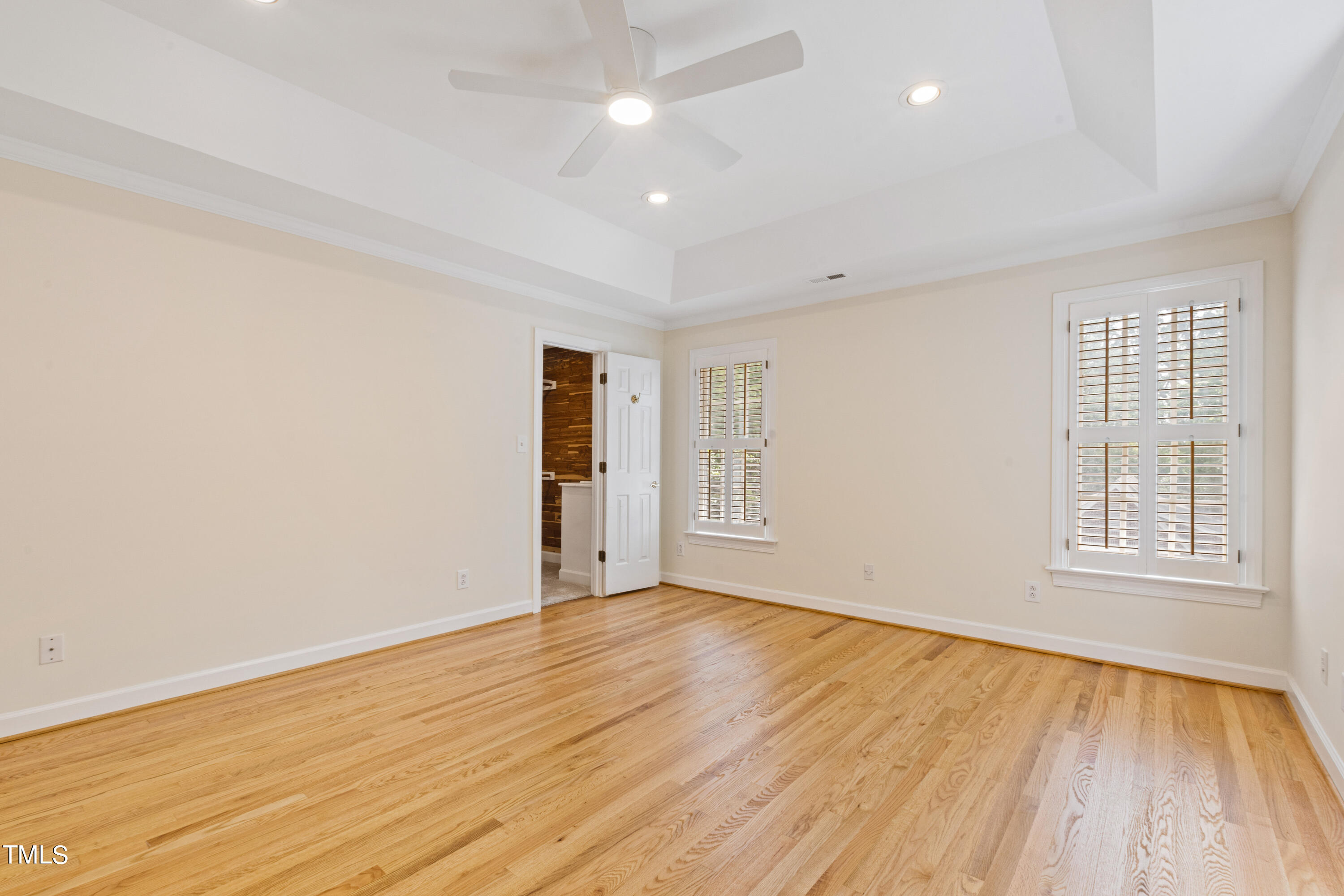 1804 Mcdonald Lane Raleigh, NC 27608 - Photo 33 of 62 an empty room with wooden floor and windows