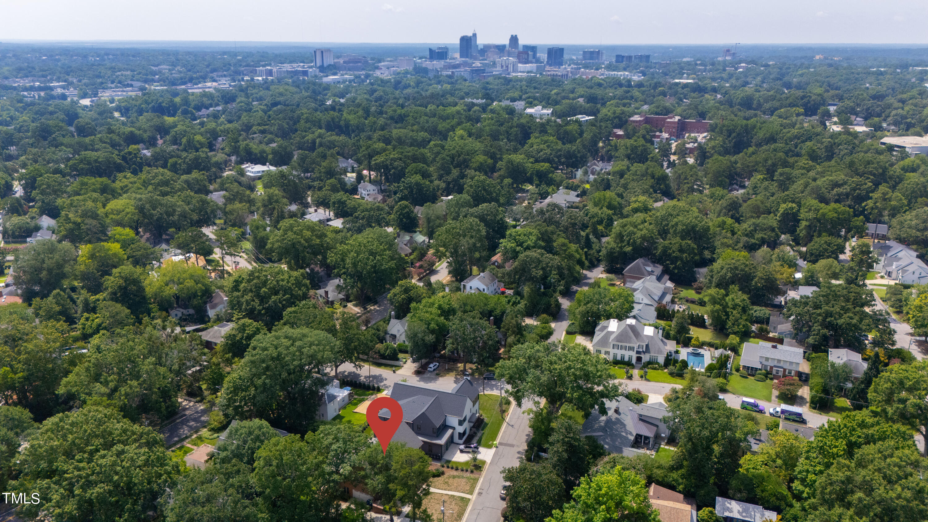 1804 Mcdonald Lane Raleigh, NC 27608 - Photo 61 of 62 an aerial view of a houses with a lush green hillside