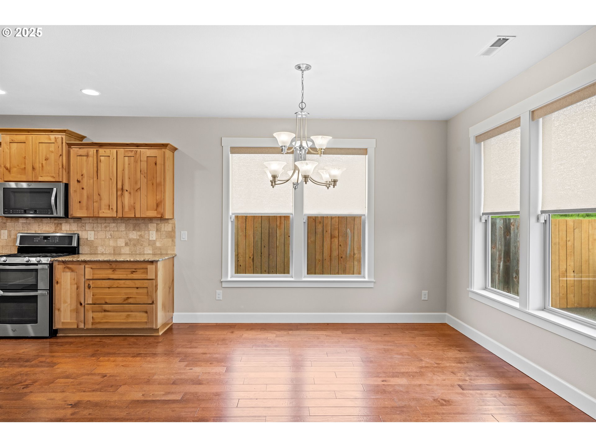 834 North 13th Place Ridgefield, WA 98642 - Photo 4 of 33 a view of an empty room with a window and wooden floor