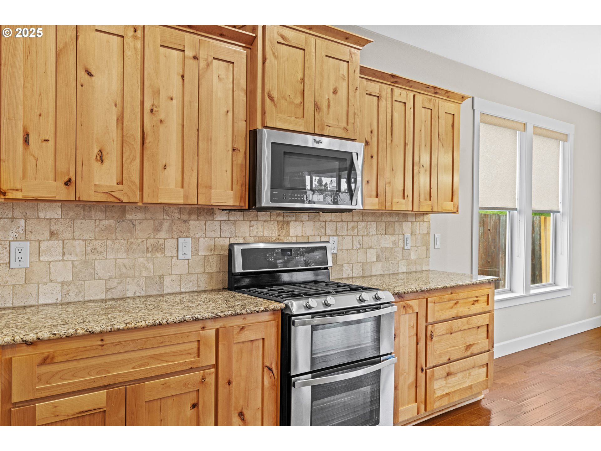 834 North 13th Place Ridgefield, WA 98642 - Photo 6 of 33 a kitchen with granite countertop cabinets stainless steel appliances and a window