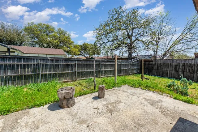 a view of a chair and table in the garden
