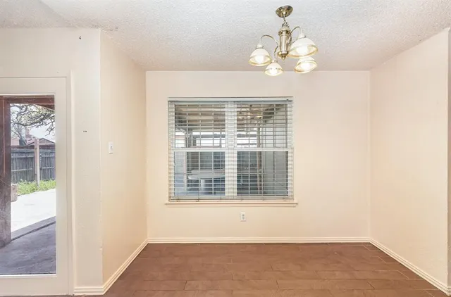 a view of wooden floor and a chandelier in a room