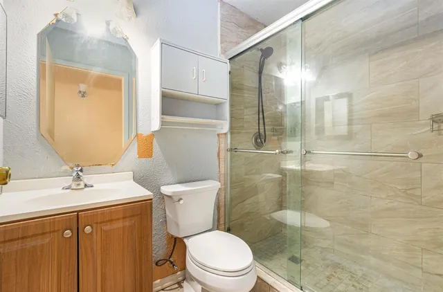 a white toilet sitting next to a bathroom sink