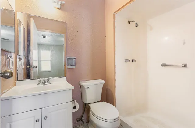 a bathroom with a sink toilet and shower