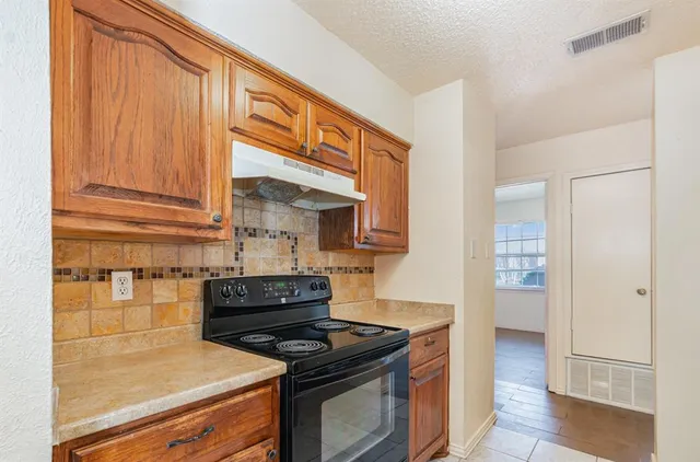 a kitchen with a stove and a refrigerator