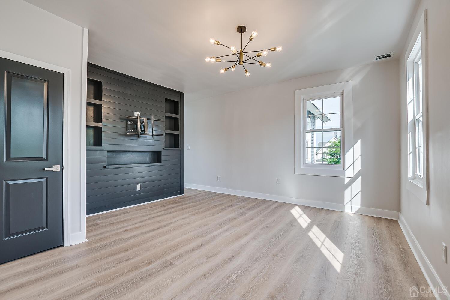 324 Main Street, Unit 2 South Amboy, NJ 08879 - Photo 13 of 26 a view of an empty room with a window and wooden floor