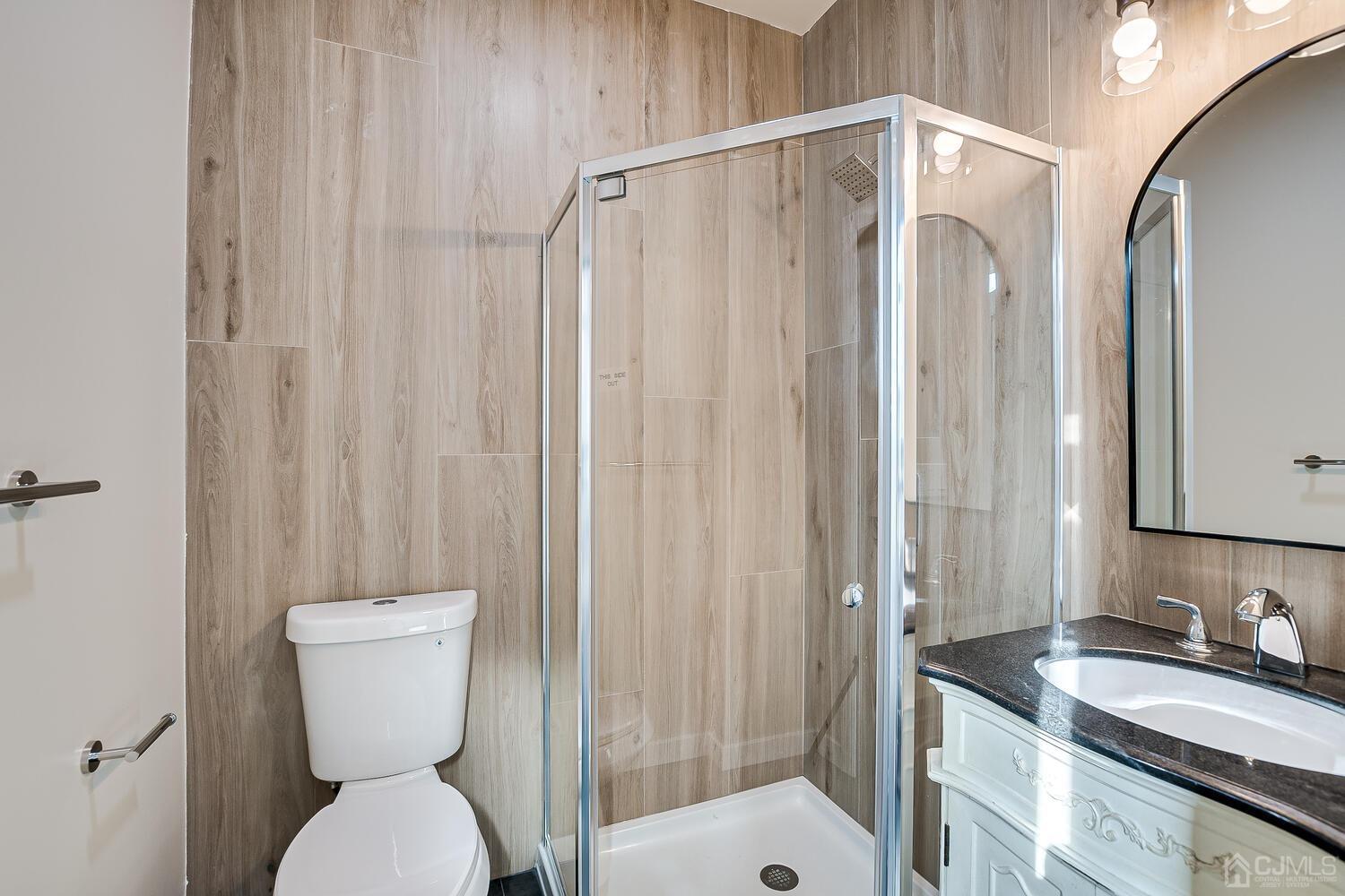 324 Main Street, Unit 2 South Amboy, NJ 08879 - Photo 16 of 26 a bathroom with a granite countertop sink toilet and shower
