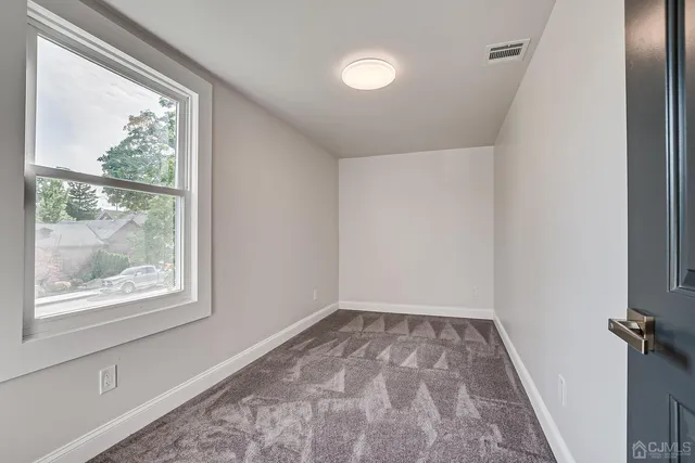 a view of room with window and hardwood floor