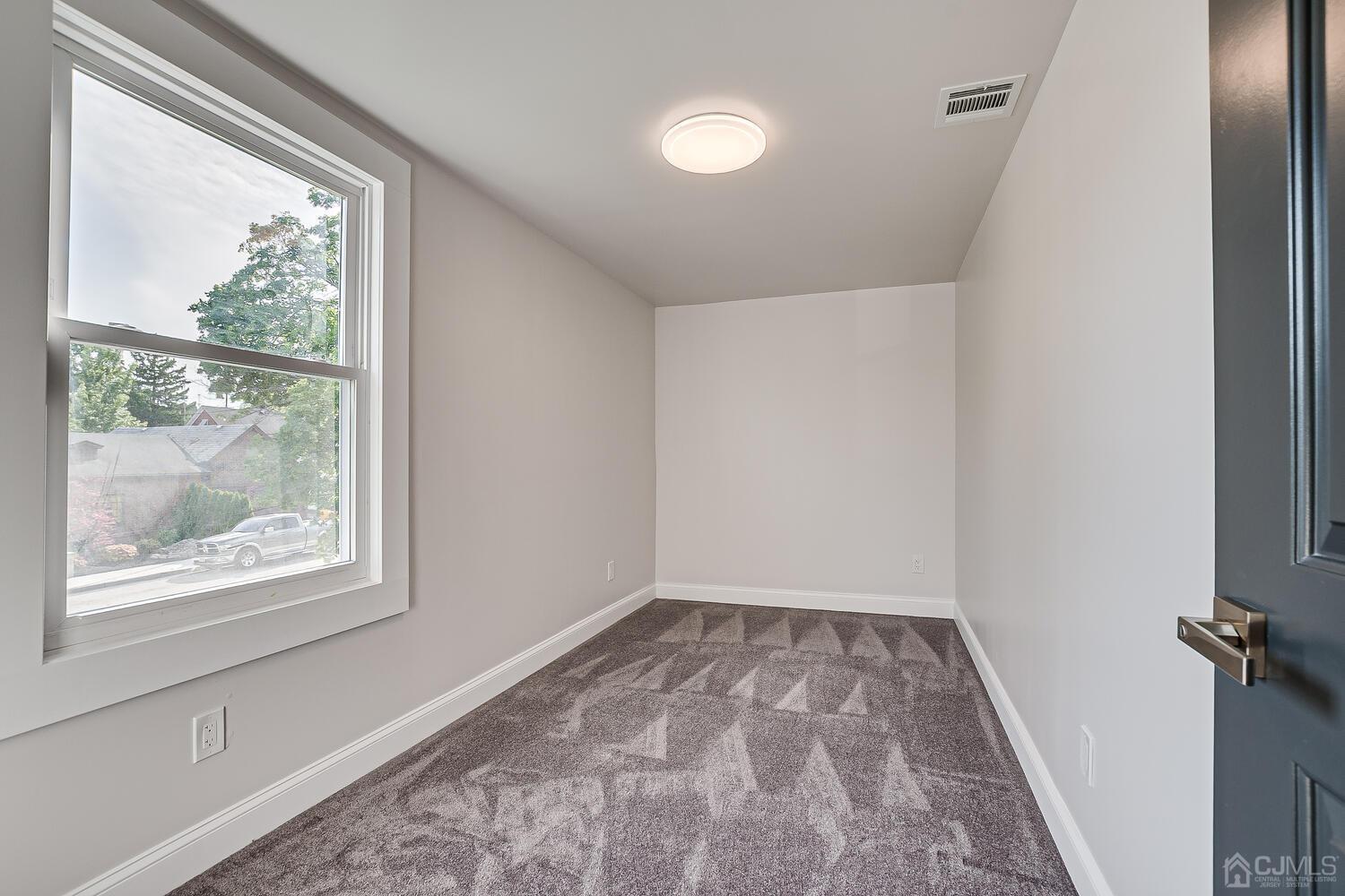 324 Main Street, Unit 2 South Amboy, NJ 08879 - Photo 21 of 26 a view of room with window and hardwood floor