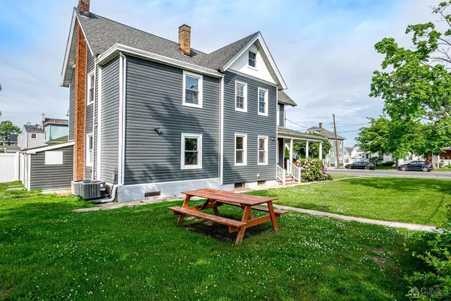 a backyard of a house with table and chairs