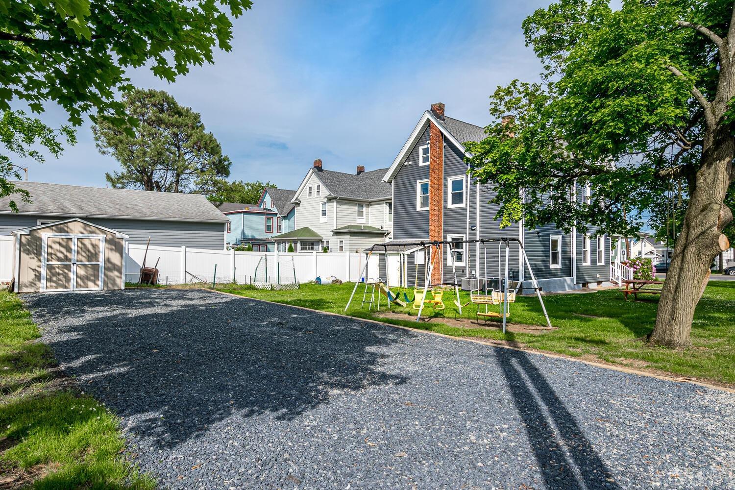 324 Main Street, Unit 2 South Amboy, NJ 08879 - Photo 24 of 26 a front view of a house with a yard and pathway
