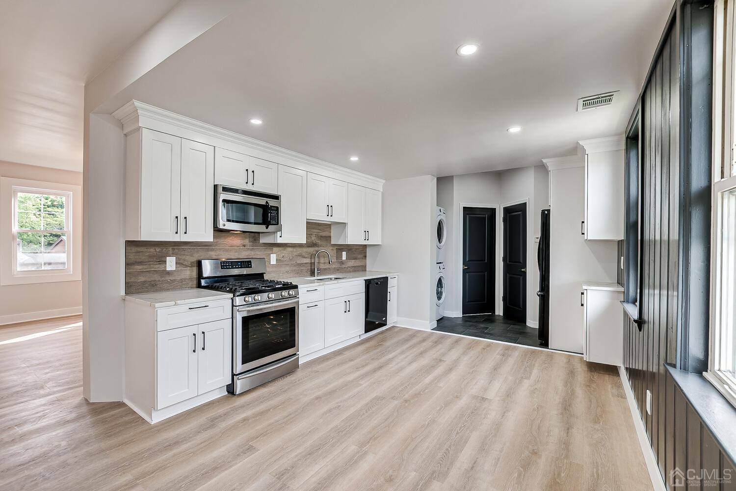 324 Main Street, Unit 2 South Amboy, NJ 08879 - Photo 6 of 26 a kitchen with stainless steel appliances a refrigerator sink and stove