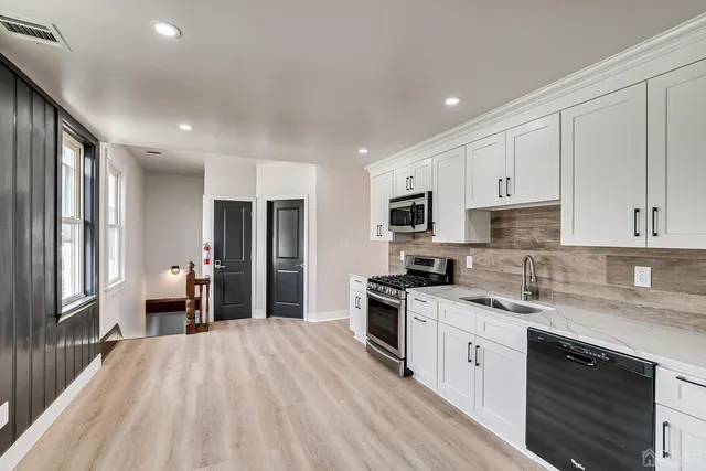 a kitchen with a stove a sink and a refrigerator