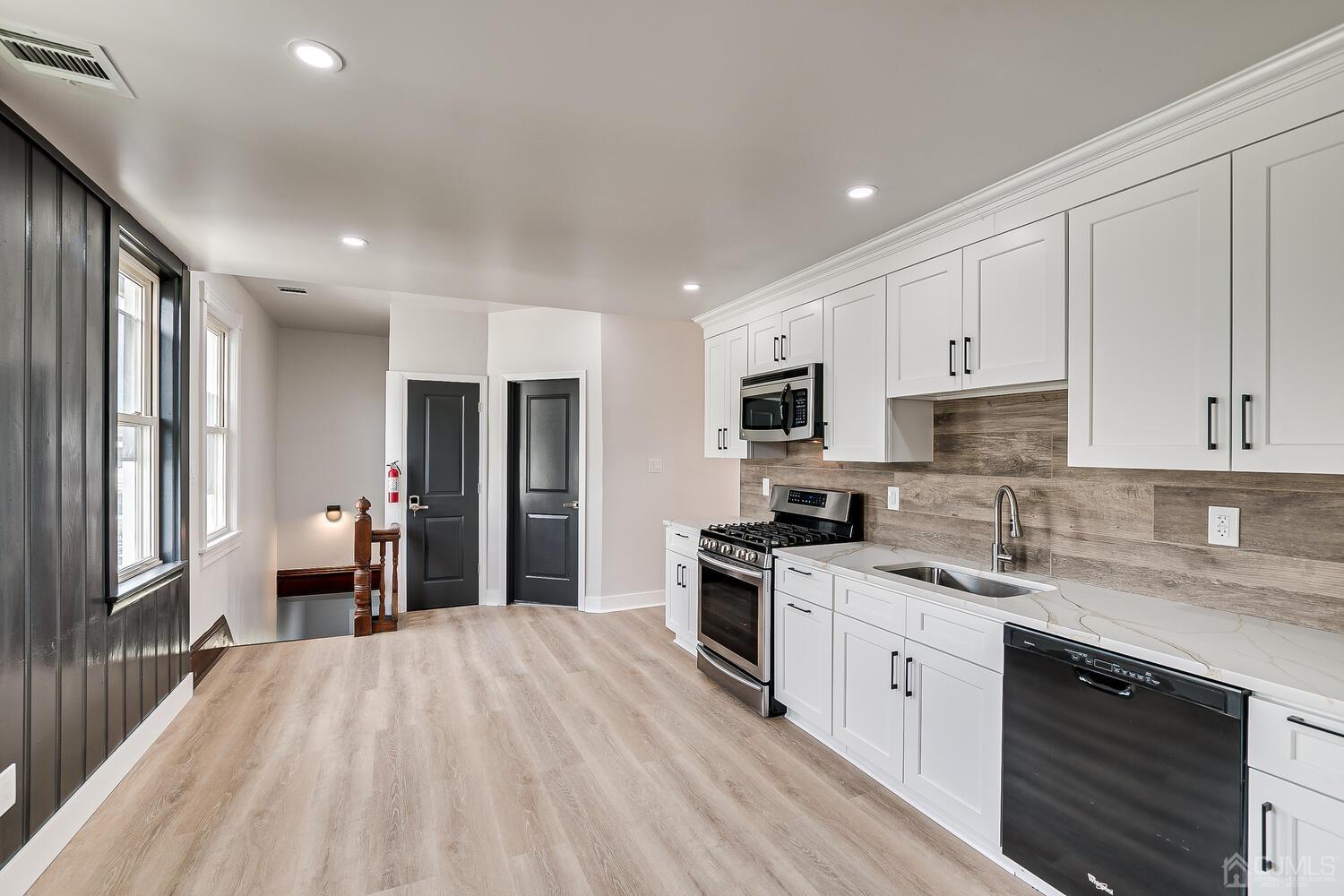 324 Main Street, Unit 2 South Amboy, NJ 08879 - Photo 7 of 26 a kitchen with a stove a sink and a refrigerator