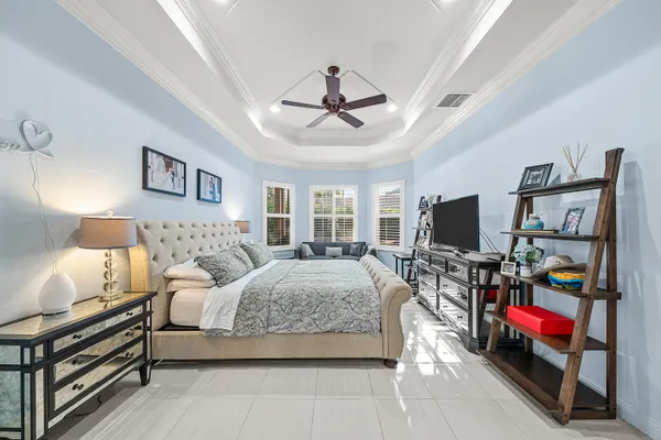 a bathroom with a granite countertop bathtub a sink and a window
