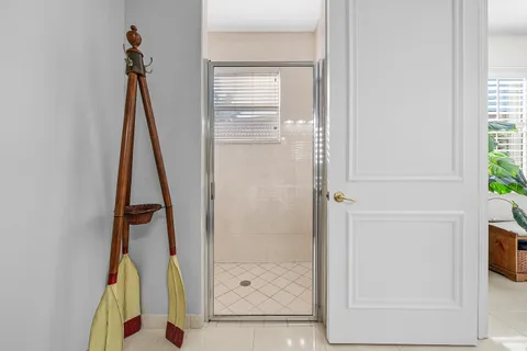 a bathroom with a tub a sink and a large mirror