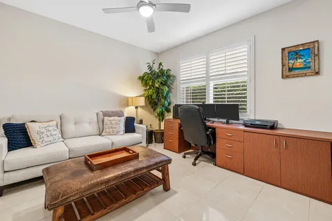 a bathroom with a granite countertop bathtub a sink and a window