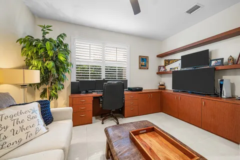 a living room with furniture a ceiling fan and a window