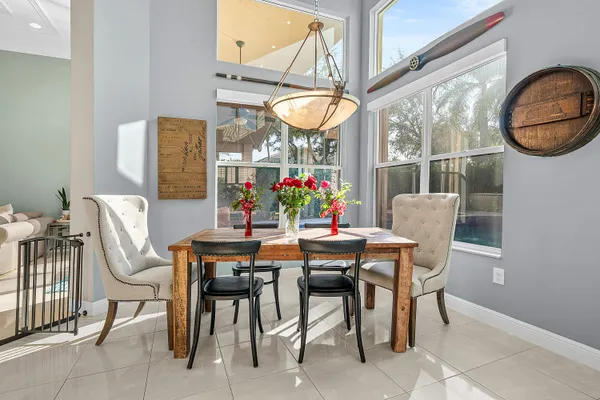 a living room with furniture a ceiling fan and a window