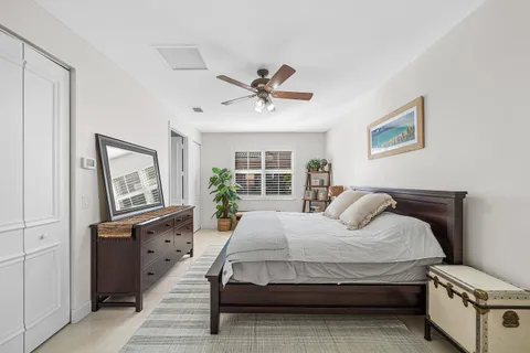a bedroom with a bed dresser and a flat tv screen