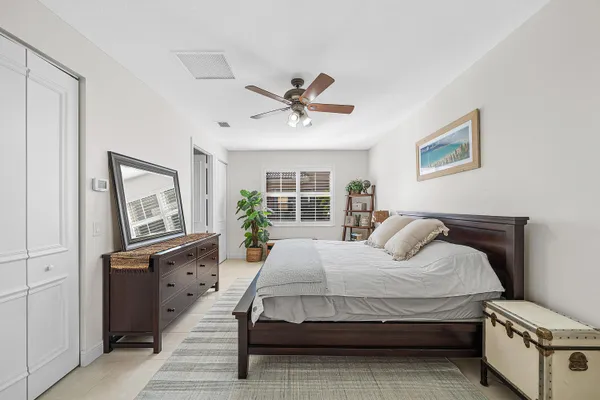 a bedroom with a bed dresser and a flat tv screen
