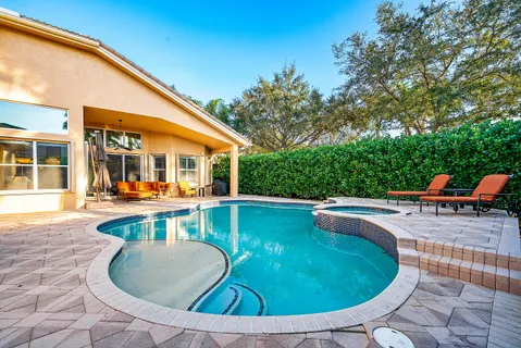 a front view of a house with a yard and a garage