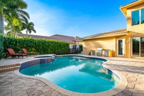 an aerial view of residential houses with outdoor space and swimming pool