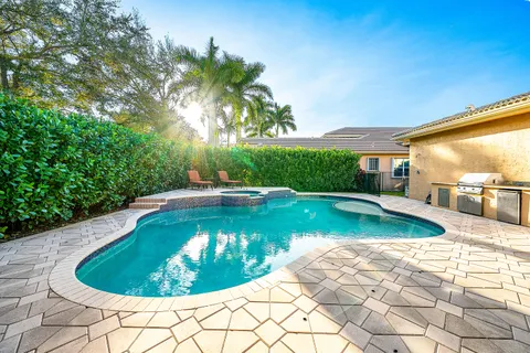 an aerial view of residential houses with outdoor space and swimming pool