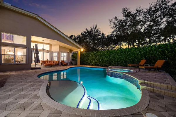 a view of swimming pool with a table and chairs