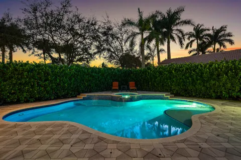 a view of swimming pool with a table and chairs
