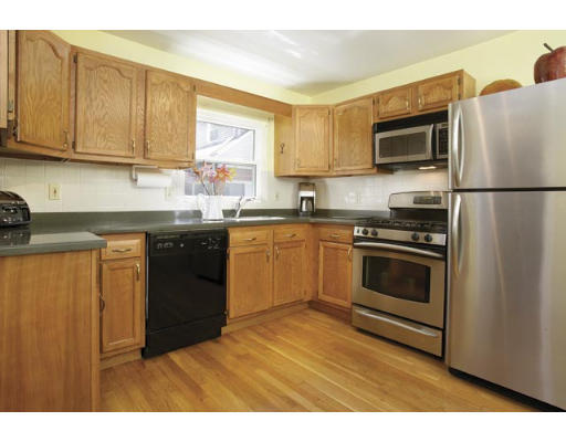 48 Loveland Road, Unit 1 Brookline, MA 02445 - Photo 3 of 6 a kitchen with stainless steel appliances granite countertop a stove a sink dishwasher and a refrigerator
